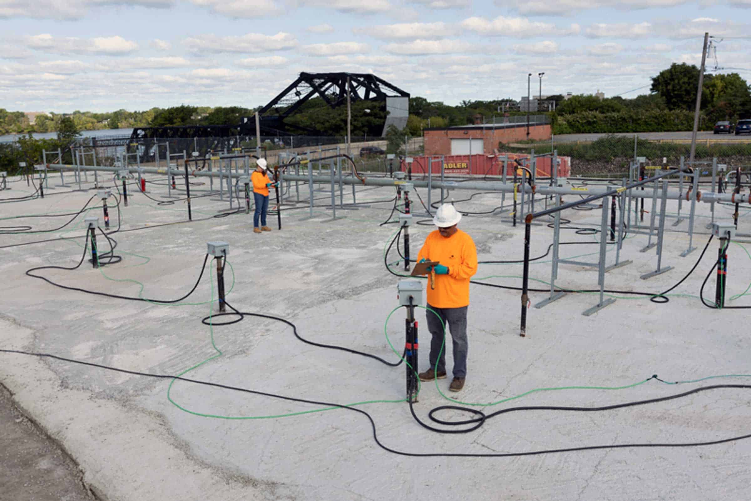 Two employees providing thermal remediation services on a TerraTherm wellfield